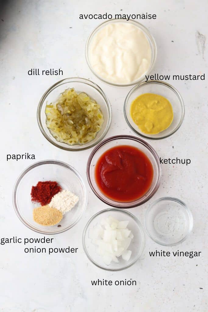Ingredients for sauce in glass bowls on tabletop.