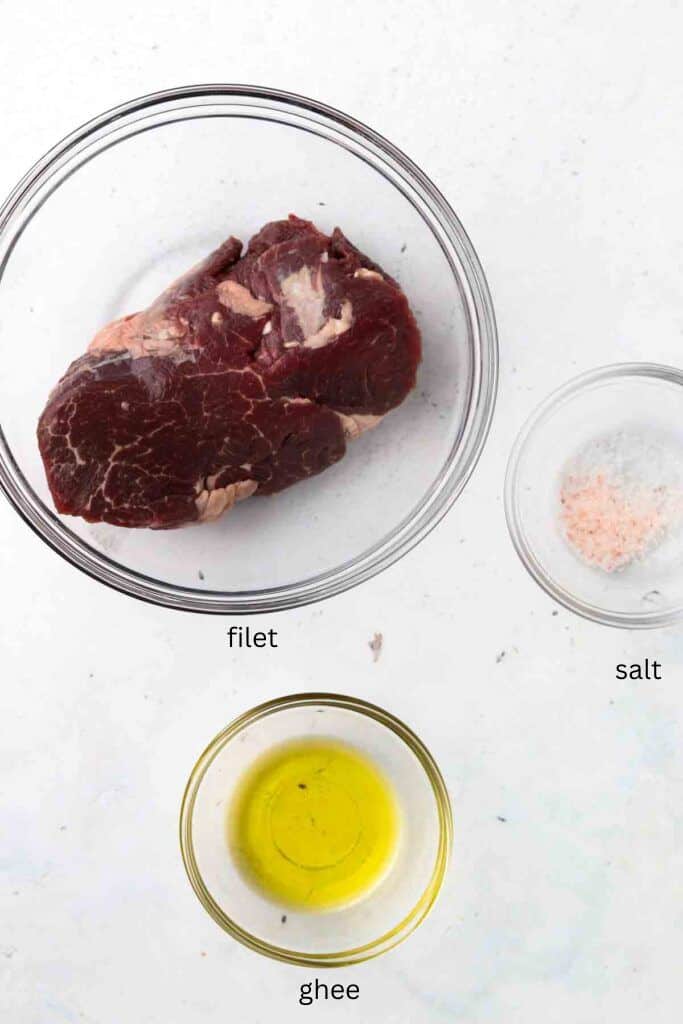 Filet steak ingredients in glass bowls.