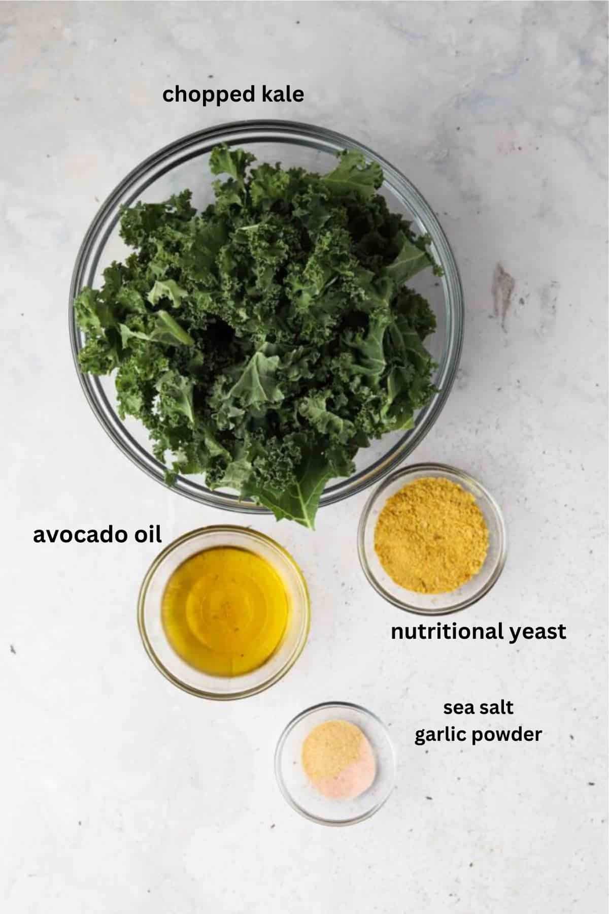 Dehydrated kale chip ingredients in glass bowls. 