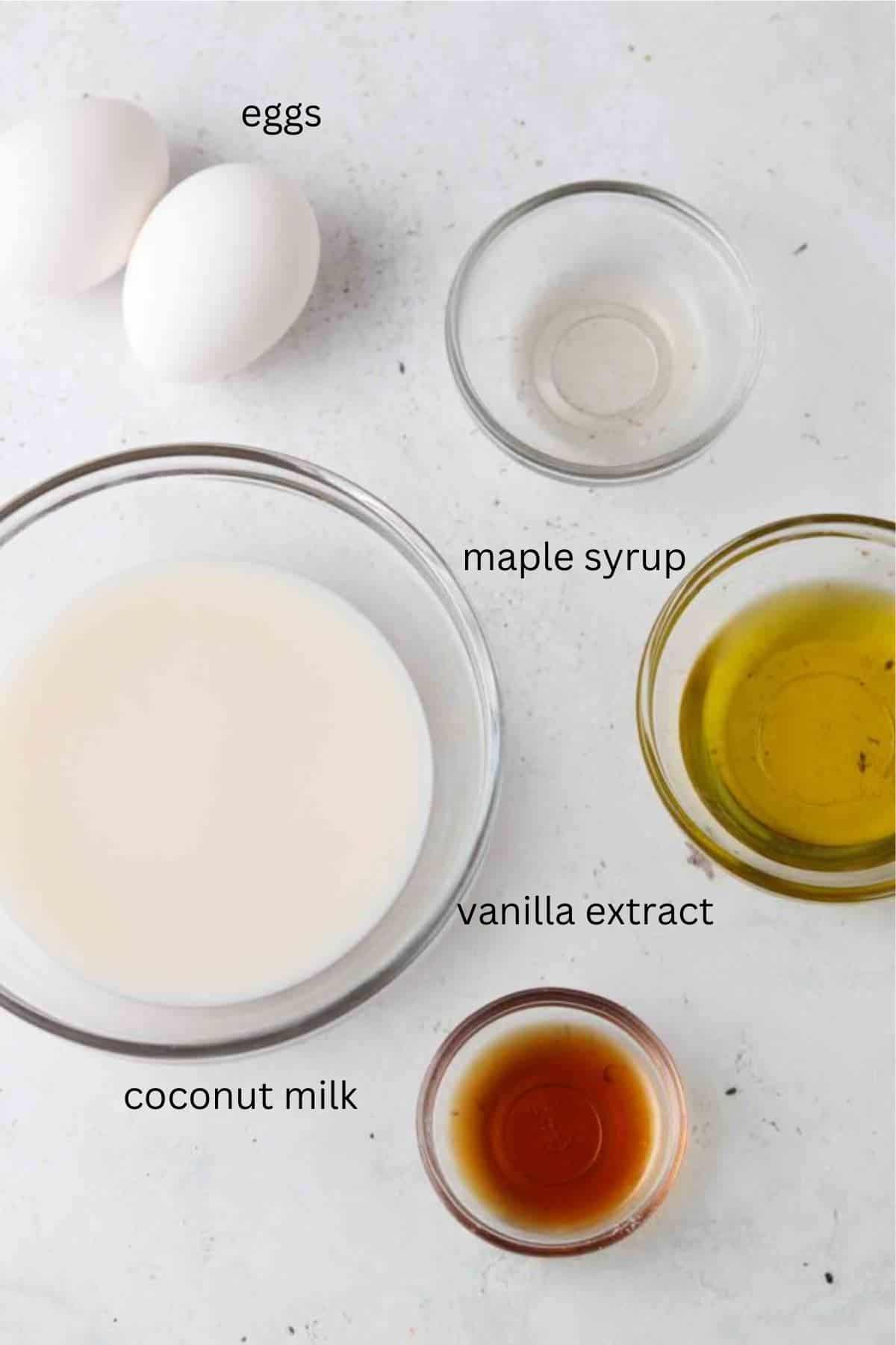 Wet ingredients for strawberry cupcakes in glass bowls.