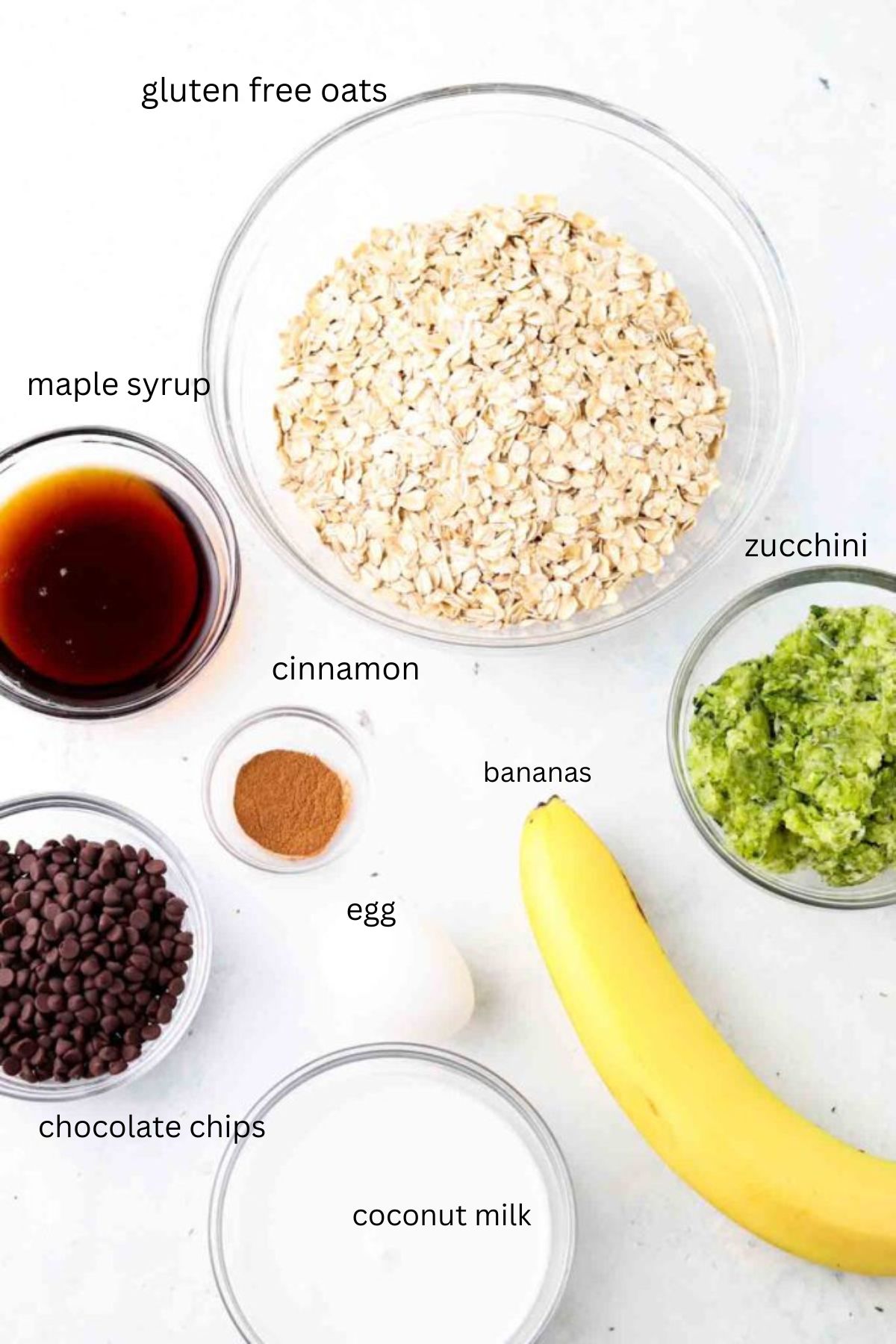 Zucchini oat bar ingredients in glass bowls.