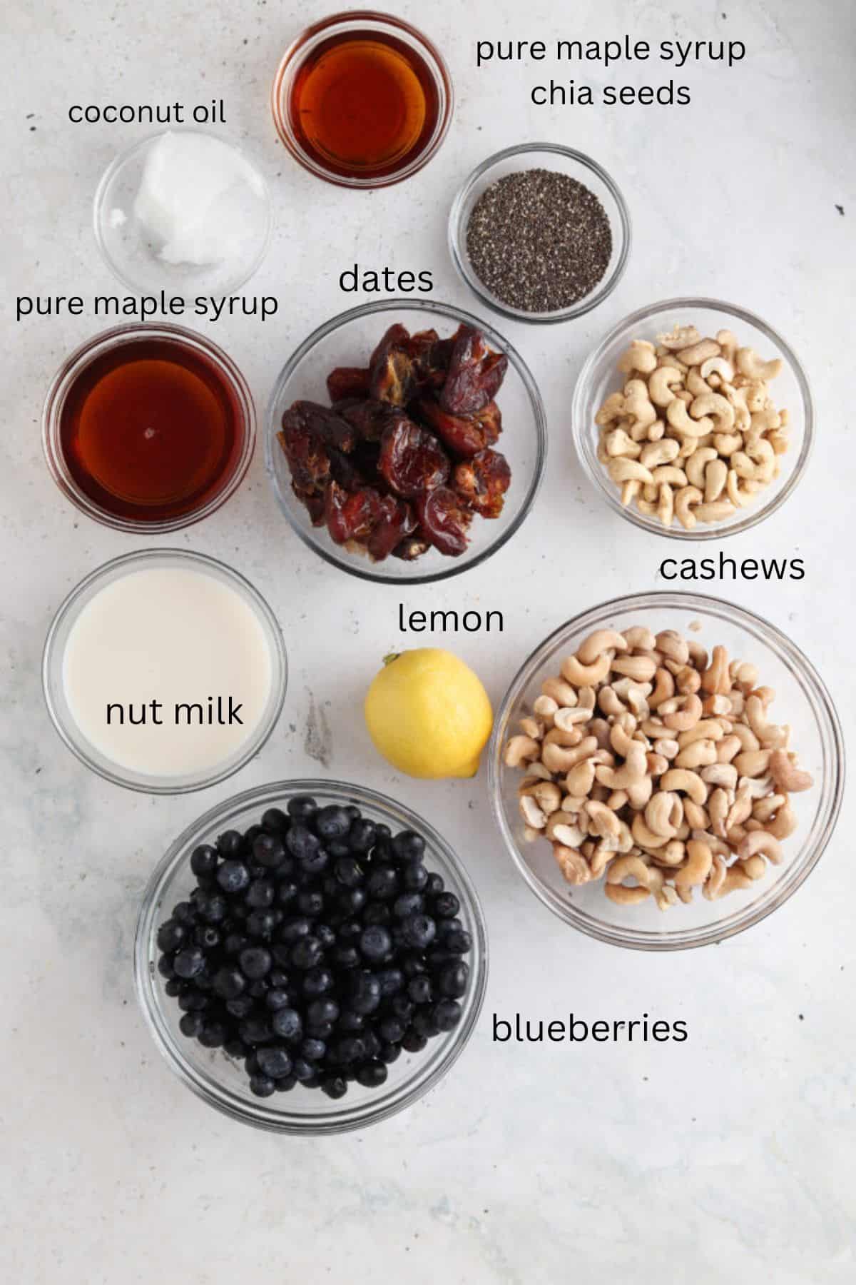 Vegan blueberry cheesecake ingredients in small glass bowls.