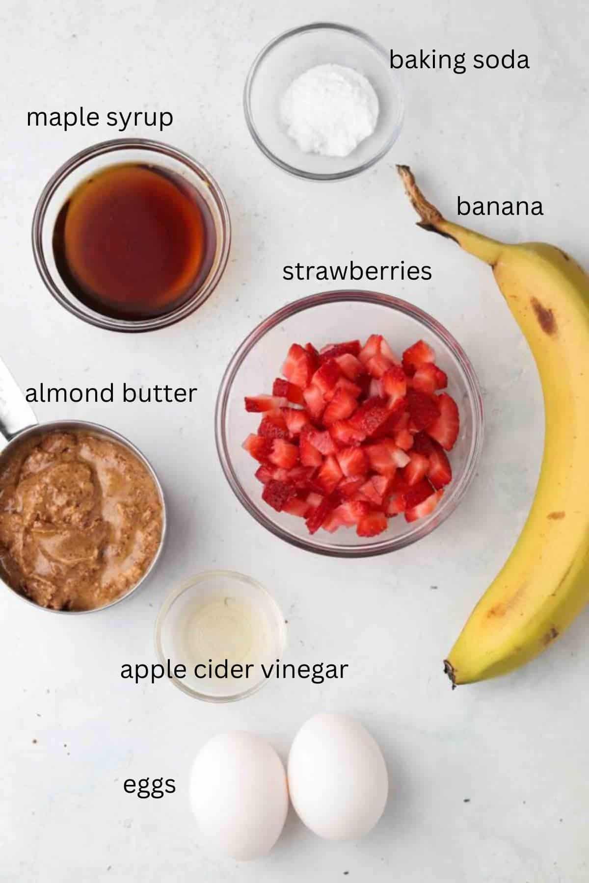 Gluten free strawberry muffin ingredients in small glass bowls. 