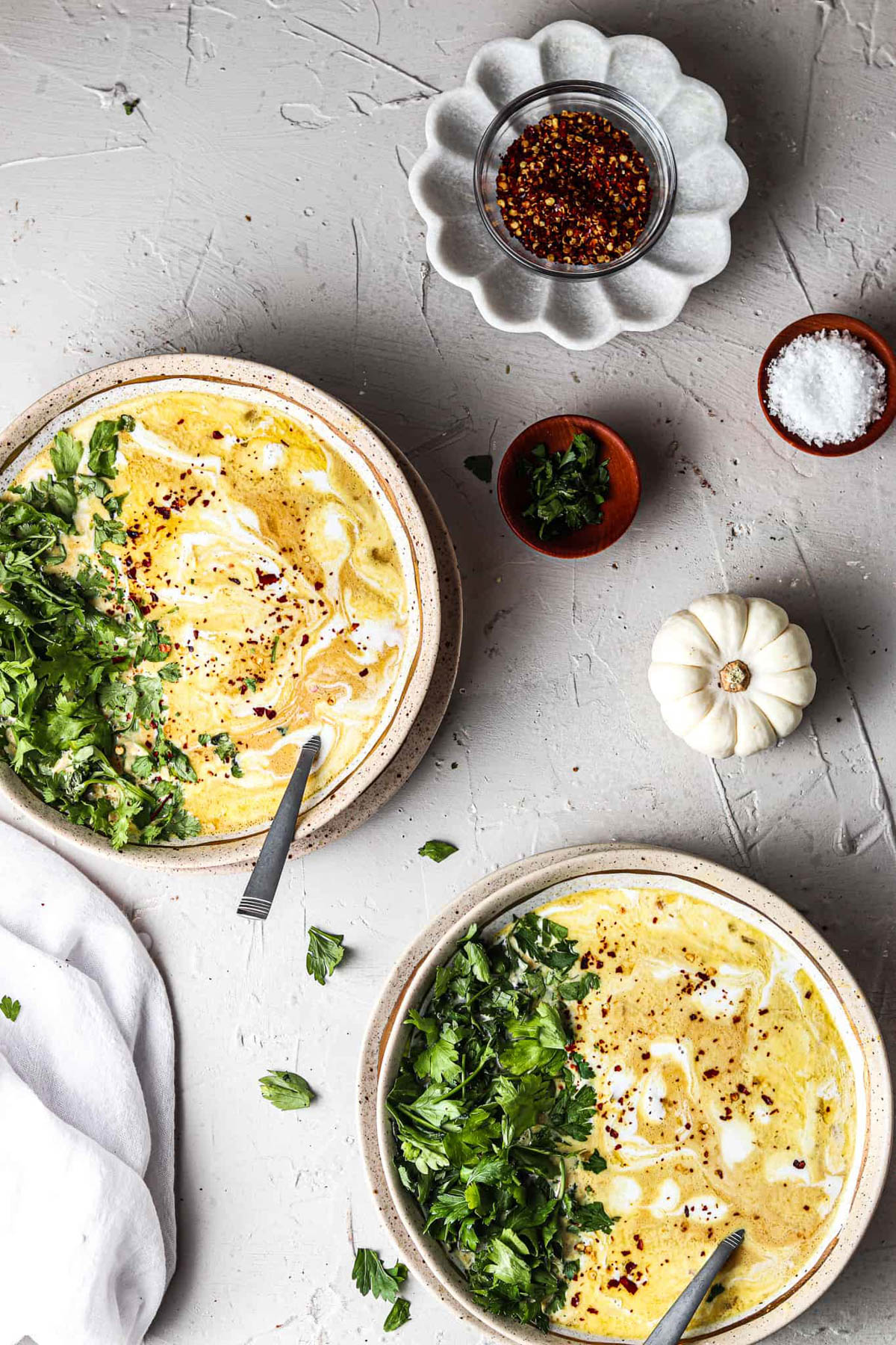 Almond Butter chicken pumpkin whole 30 instant pot soup in a bowl with fresh herbs and a small white pumpkin next to it. 