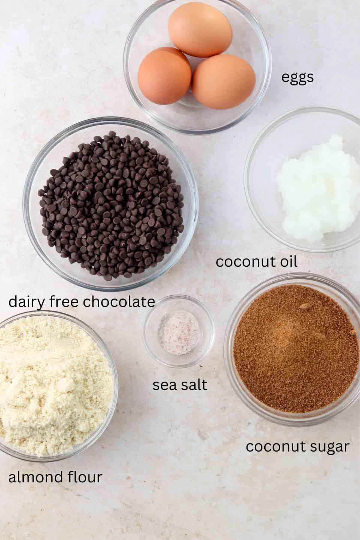 Dairy free chocolate brownie ingredients laid out in small glass bowls. 