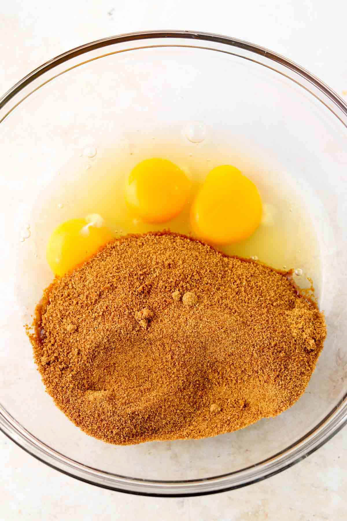 Coconut sugar and eggs in a mixing bowl for diary free brownie batter. 