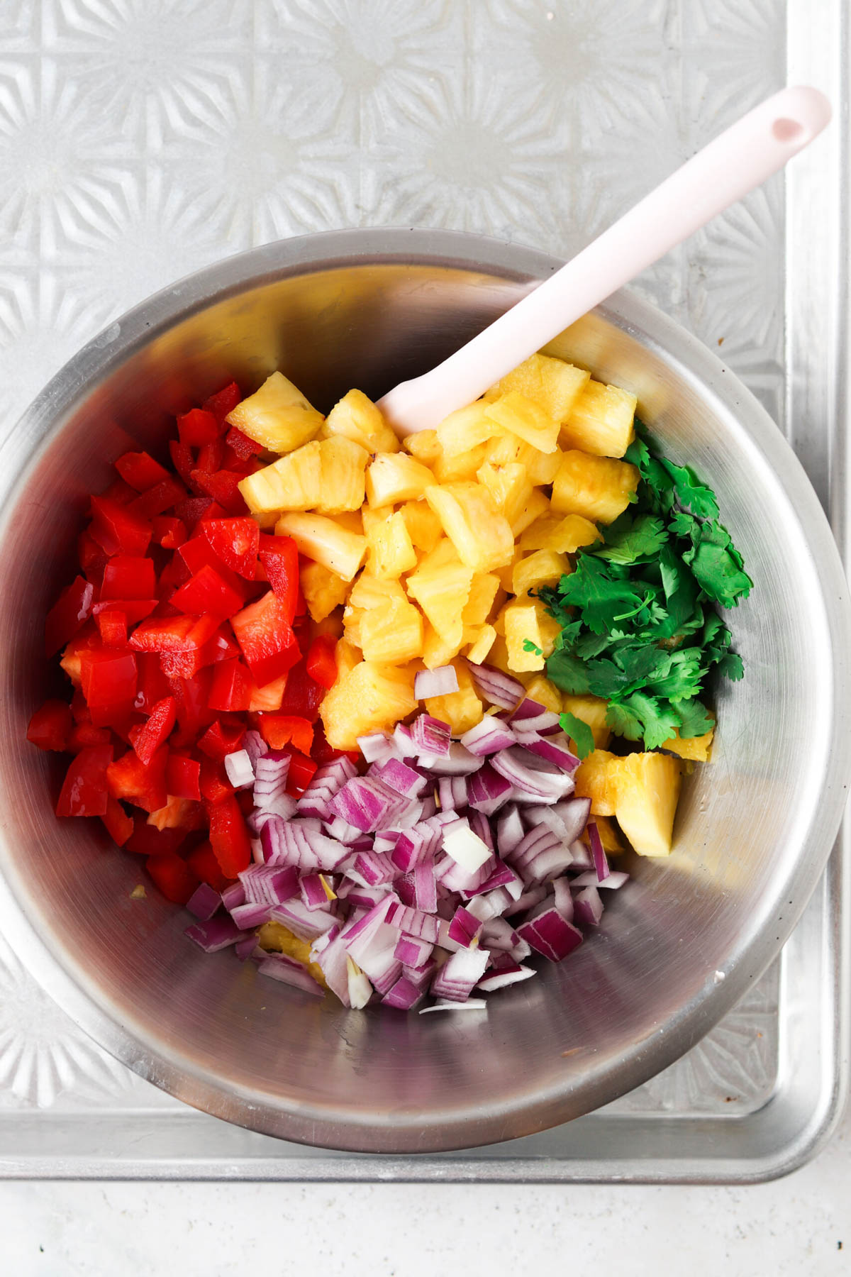 Tropical pico de gallo ingredients chopped in a mixing bowl.