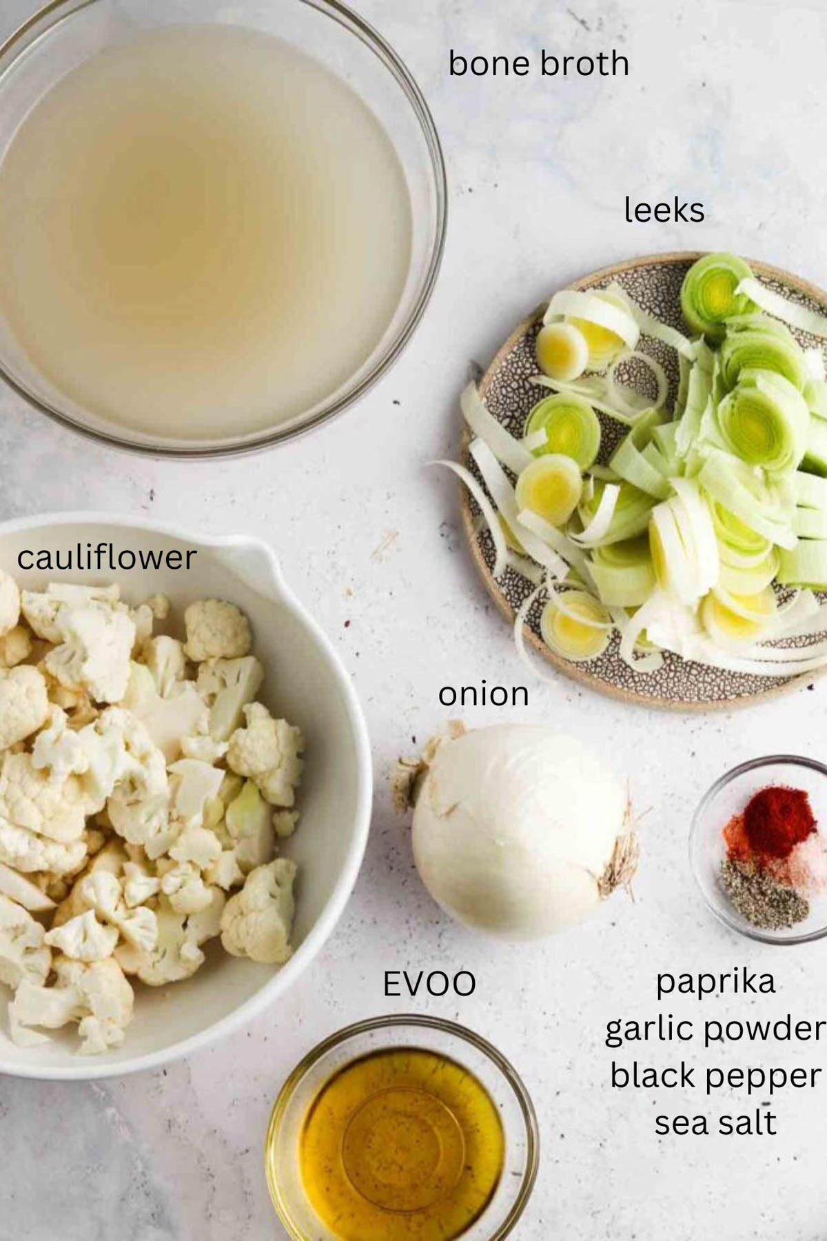 Cauliflower leek soup ingredients in small glass bowls. 