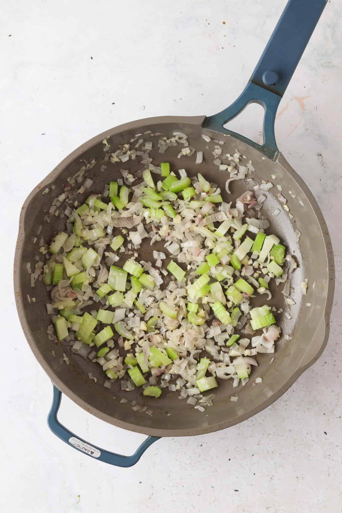 Sautéed onions and celery in a sauce pan.