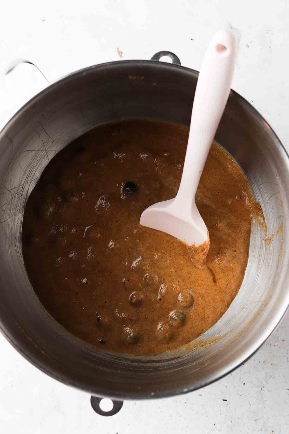 All bread ingredients mixed together in a steel bowl.