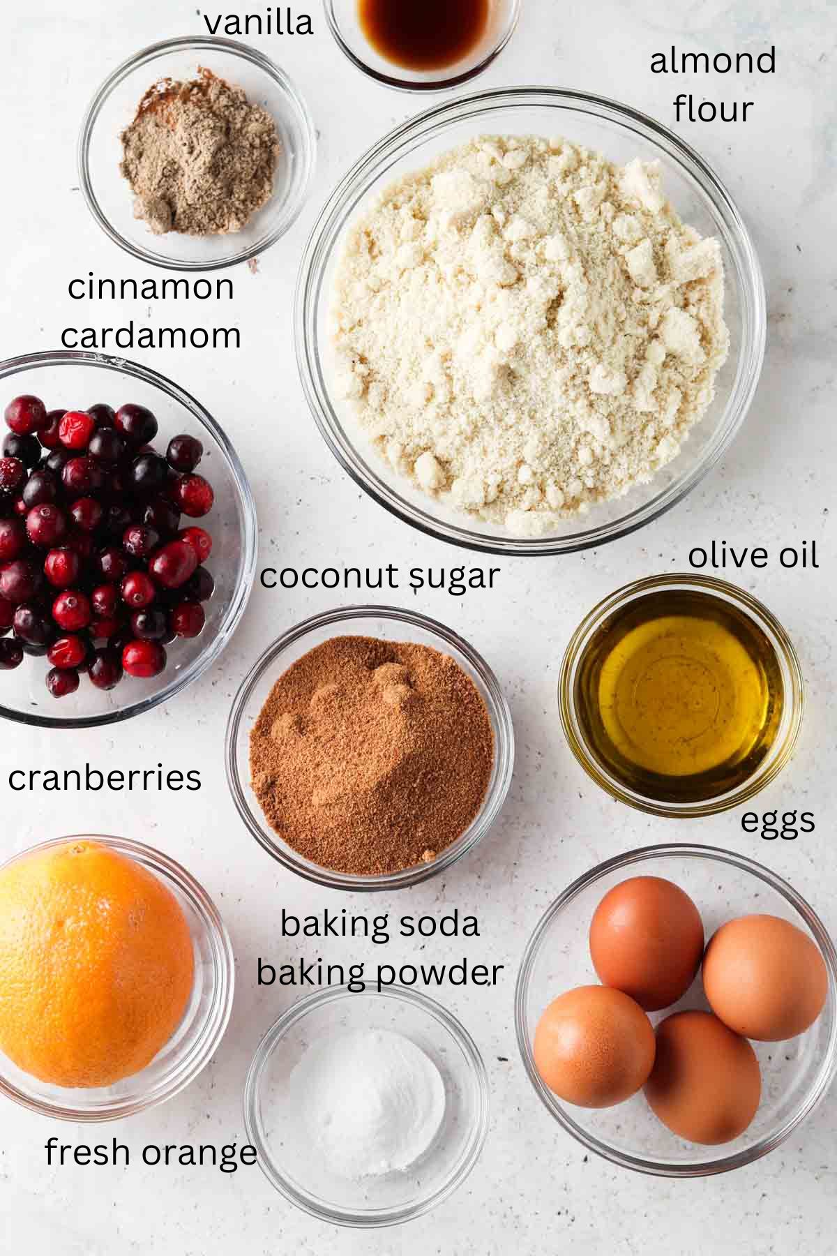 Cake ingredients in small glass bowls on a counter top.