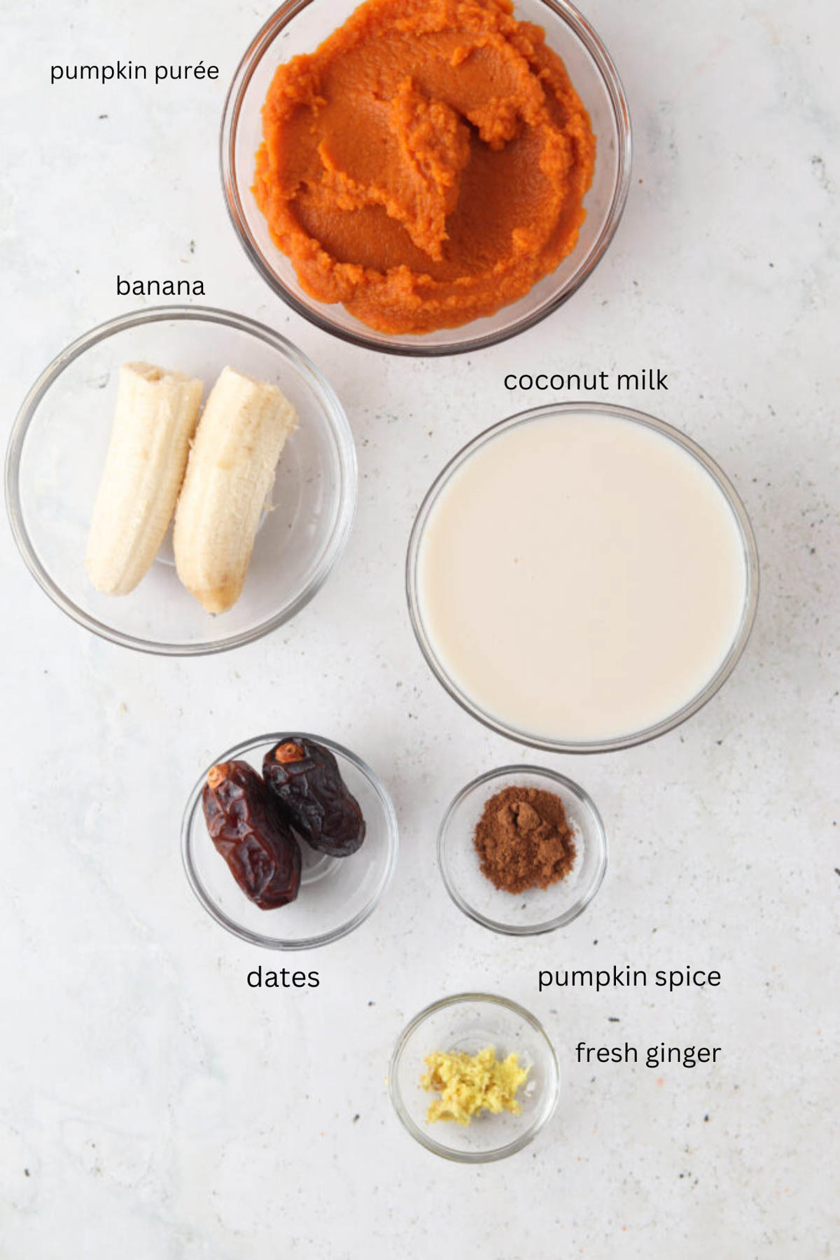 Dairy free pumpkin spice smoothie ingredients in small glass bowls.