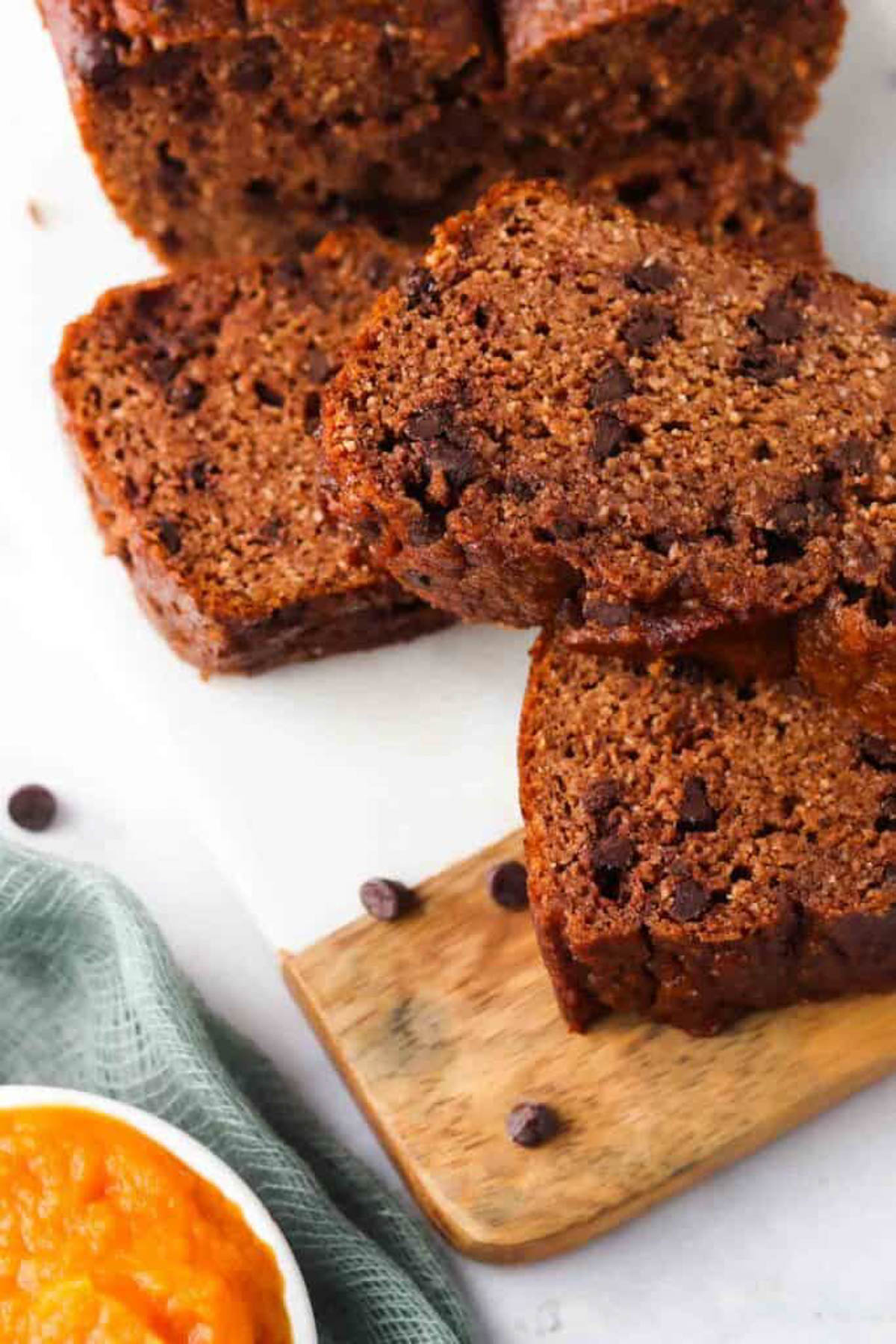 Gluten free pumpkin bread sliced on a cutting board.