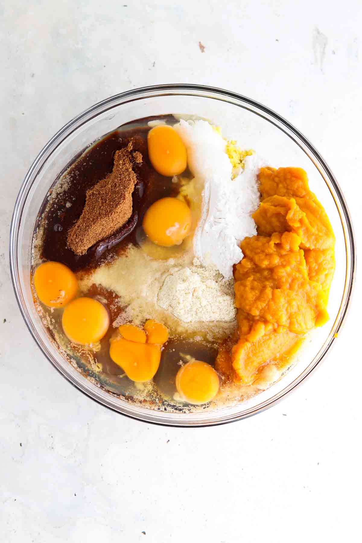 Gluten free pumpkin cake ingredients in a large glass bowl. 