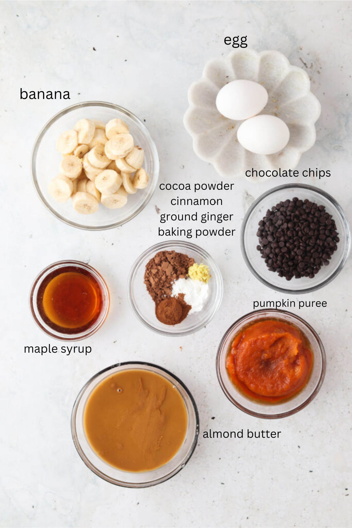 Gluten free pumpkin muffin ingredients in small glass bowls. 