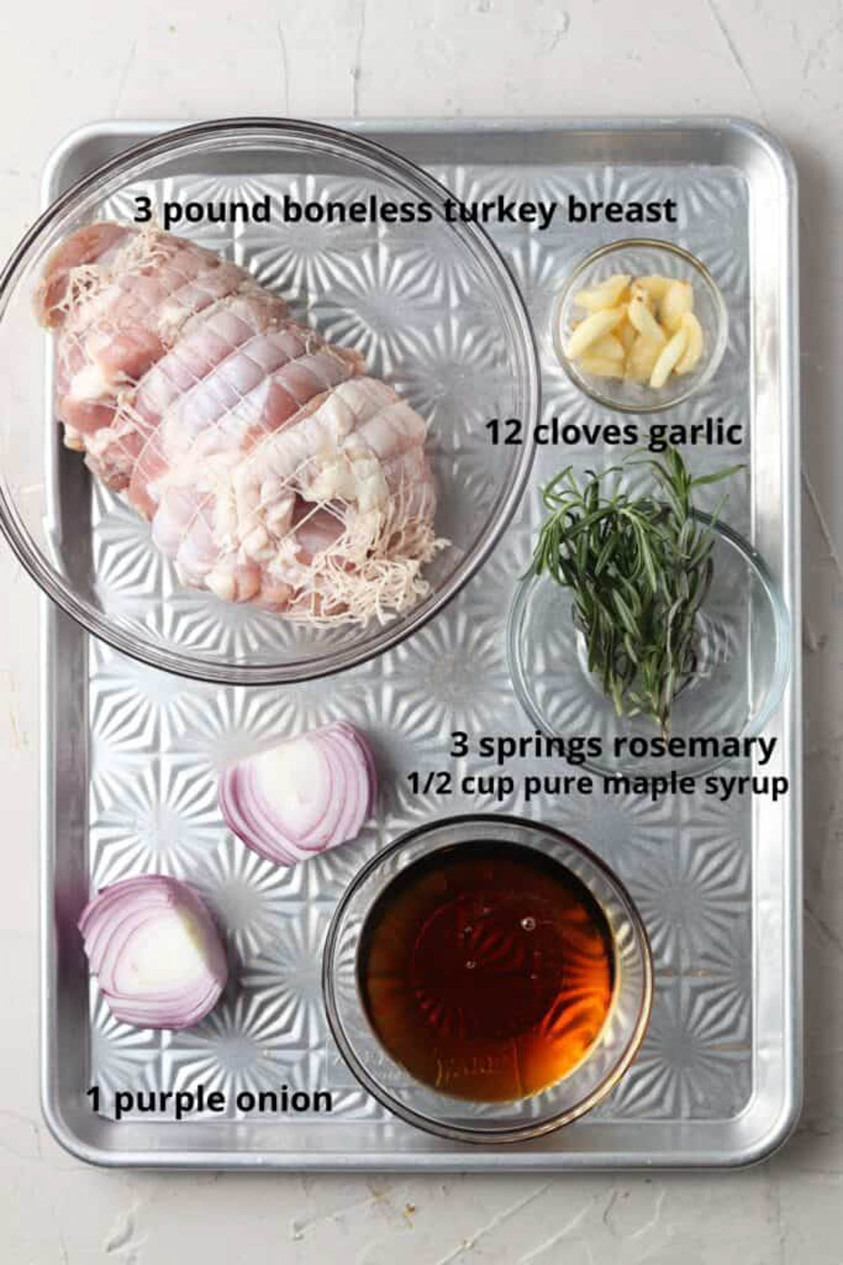 Boneless maple turkey breast recipe ingredients laid out in small glass bowls on a tray.