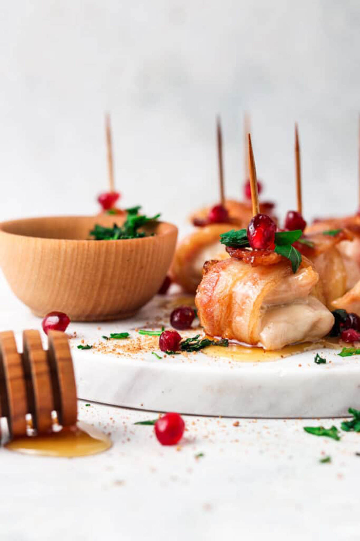 AIP bacon maple chicken bites on a marble board with maple honey drizzled.