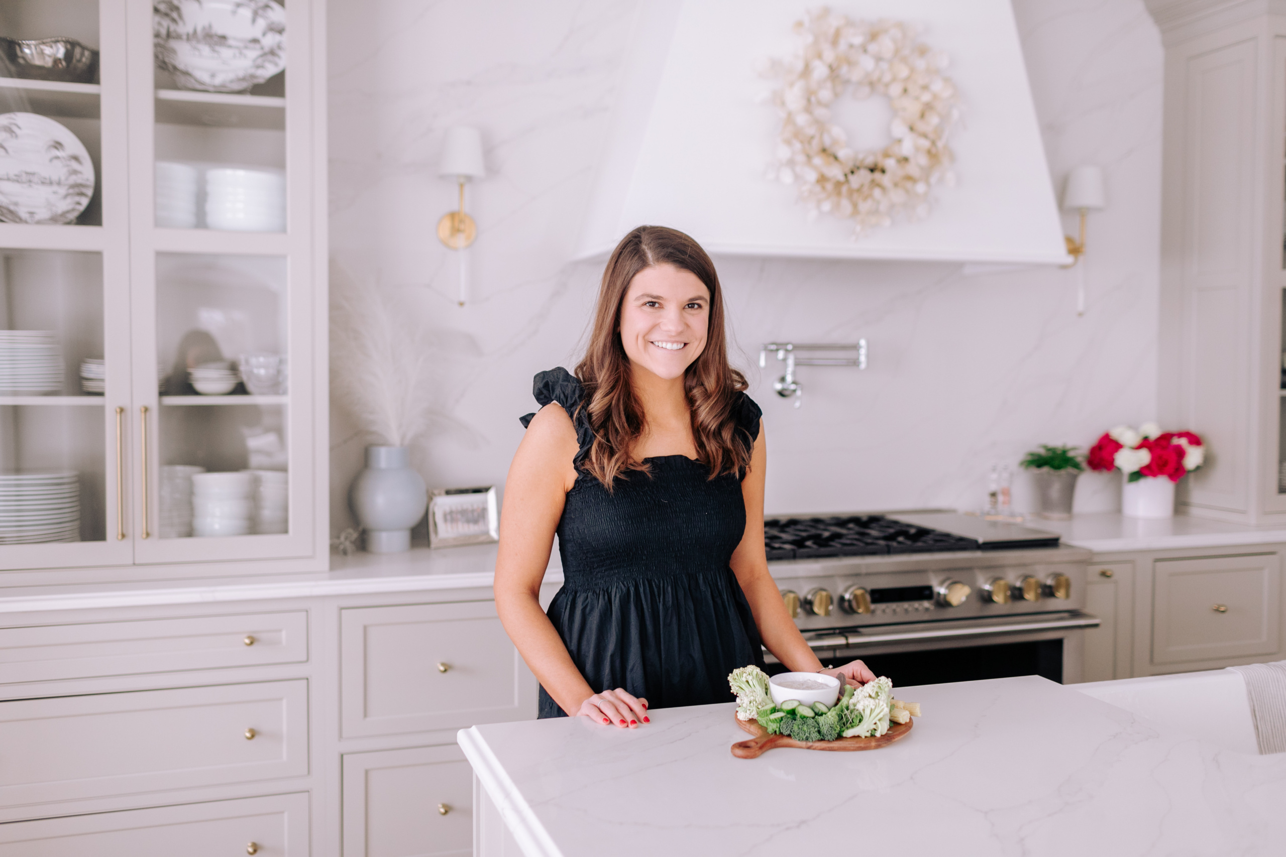 Allianna Moximchalk in the kitchen with a plate of veggies.