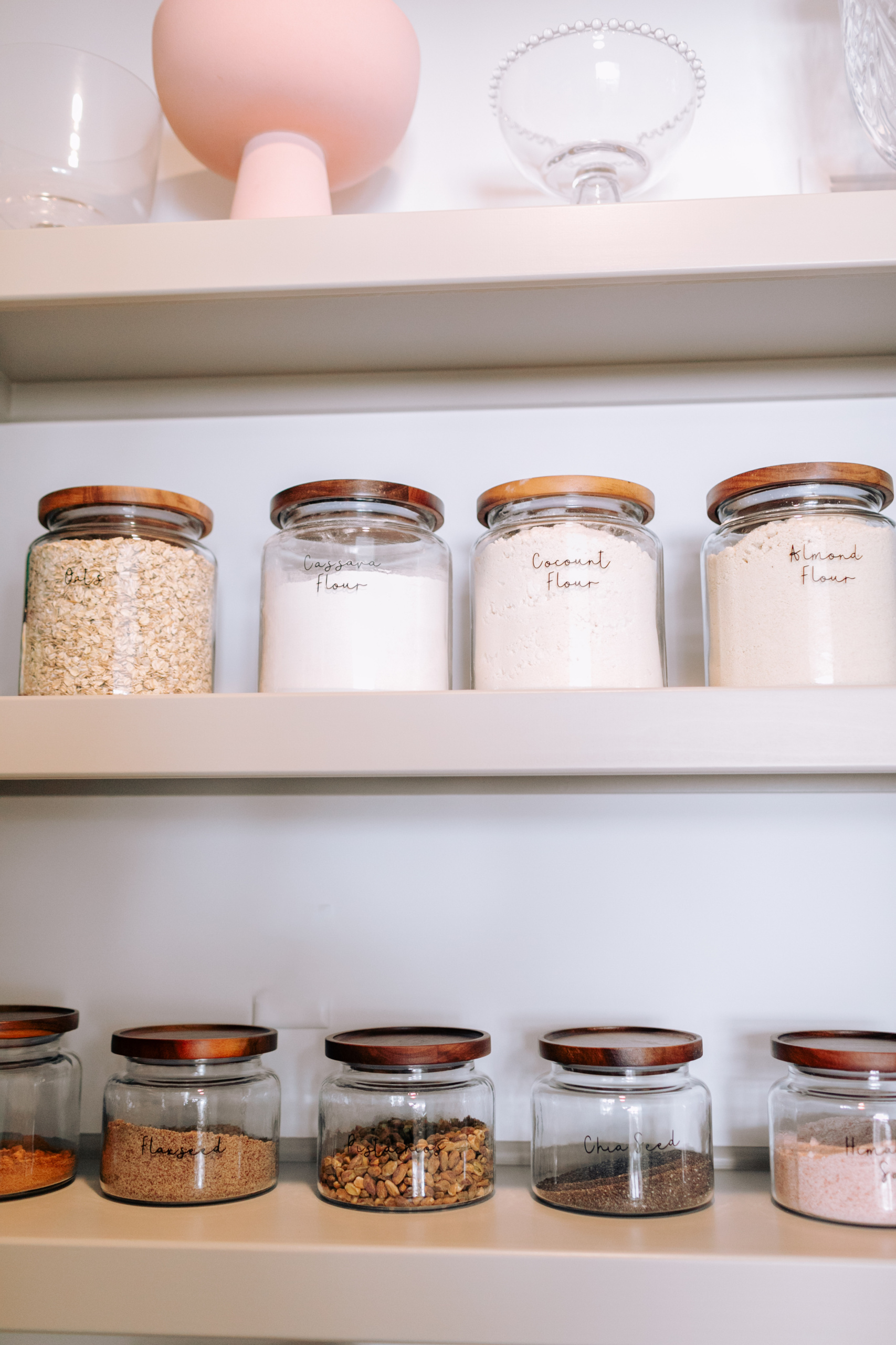 Glass pantry jars with wooden lids.