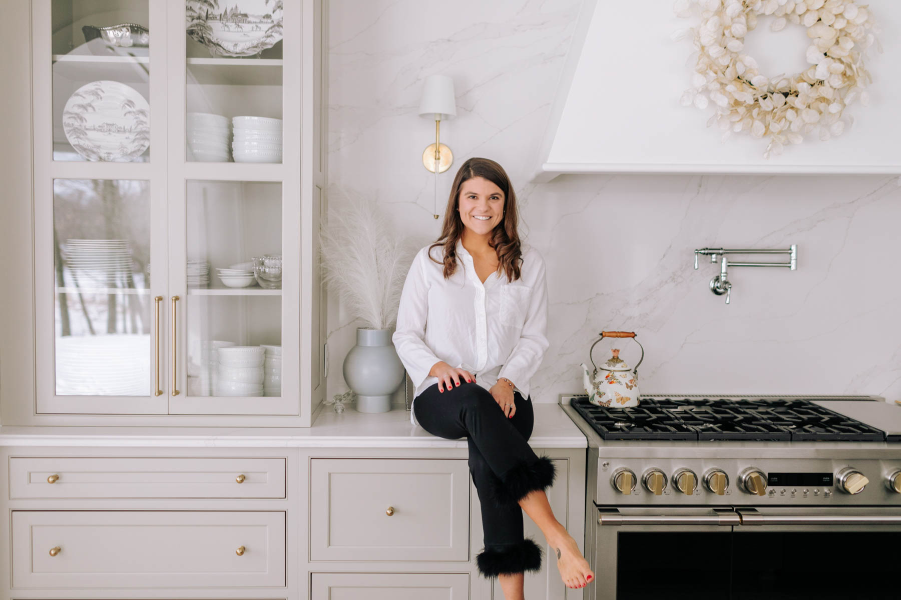 Allianna Moximchalk sitting on the counter in her kitchen.