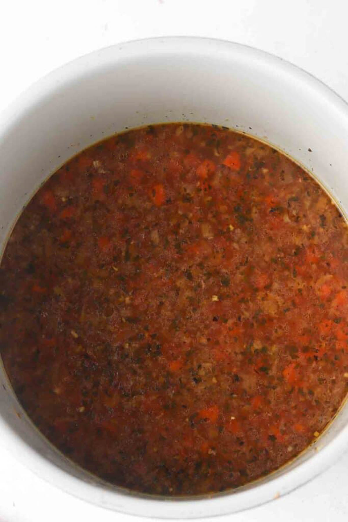 Uncooked instant pot turkey soup ingredients in a pressure cooker base.