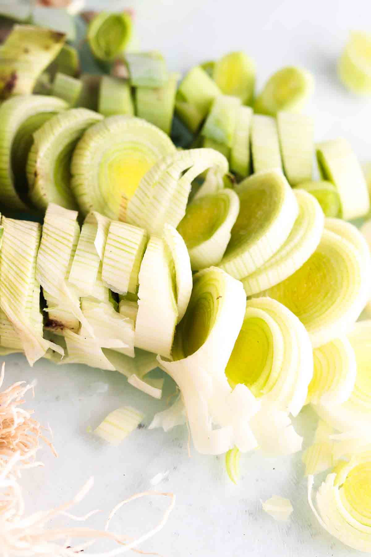 Chopped leeks on a cutting board.