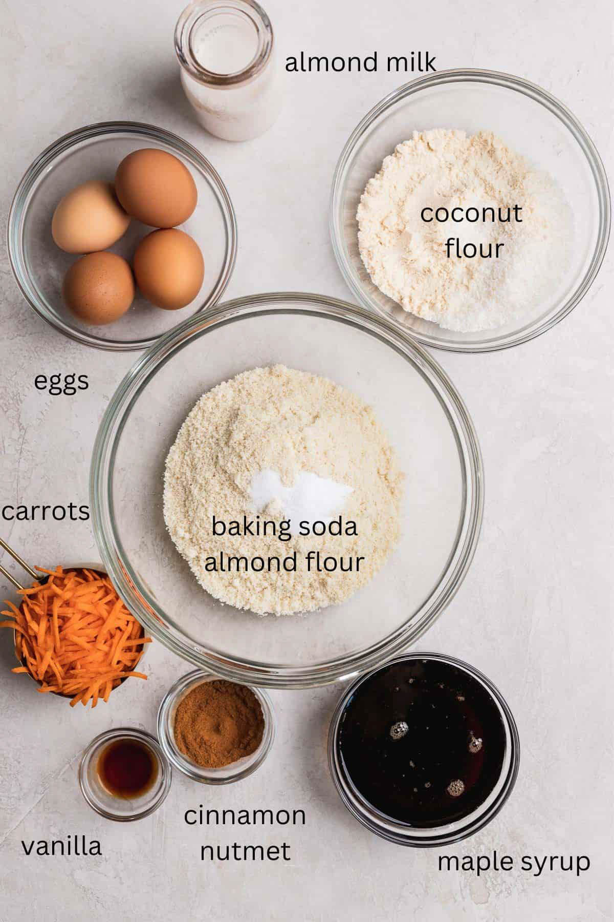 Paleo carrot cake ingredients laid out in small glass bowls. 