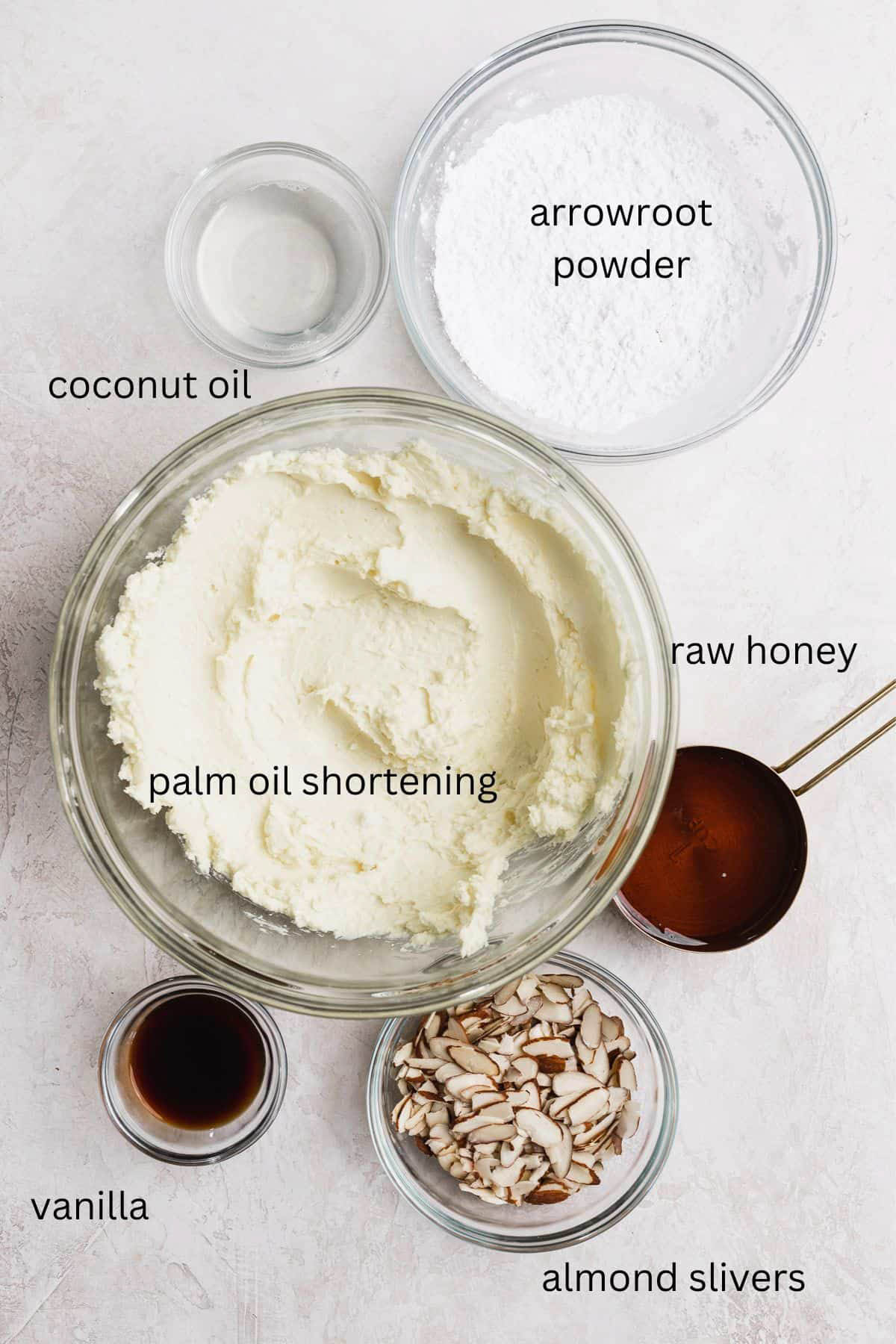 Frosting ingredients laid out in small glass bowls.