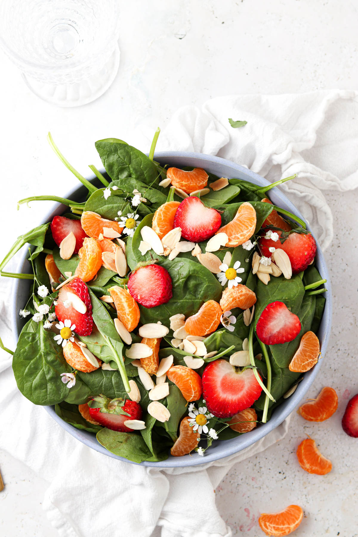 Strawberry poppyseed salad in a white bowl.