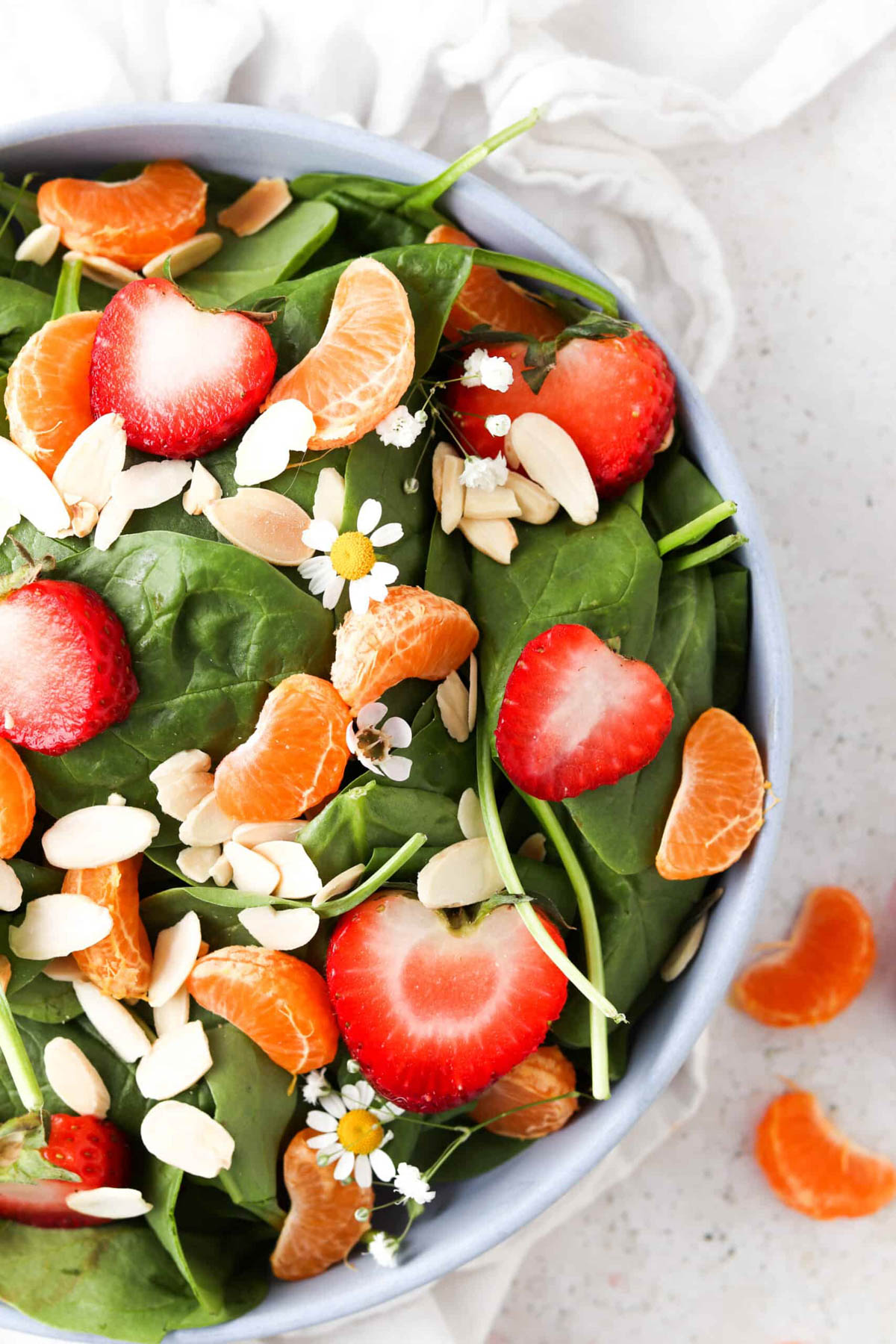 Half of a bowl of strawberry poppyseed salad.