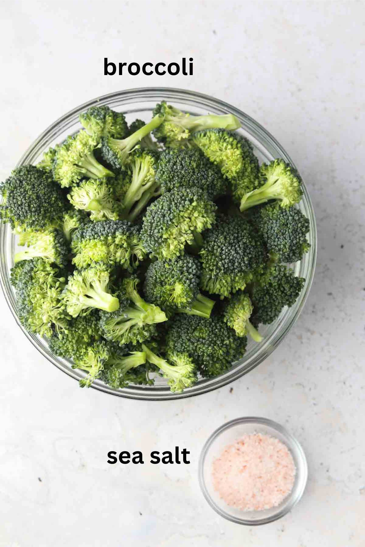 Broccoli and sea salt in glass small bowls.