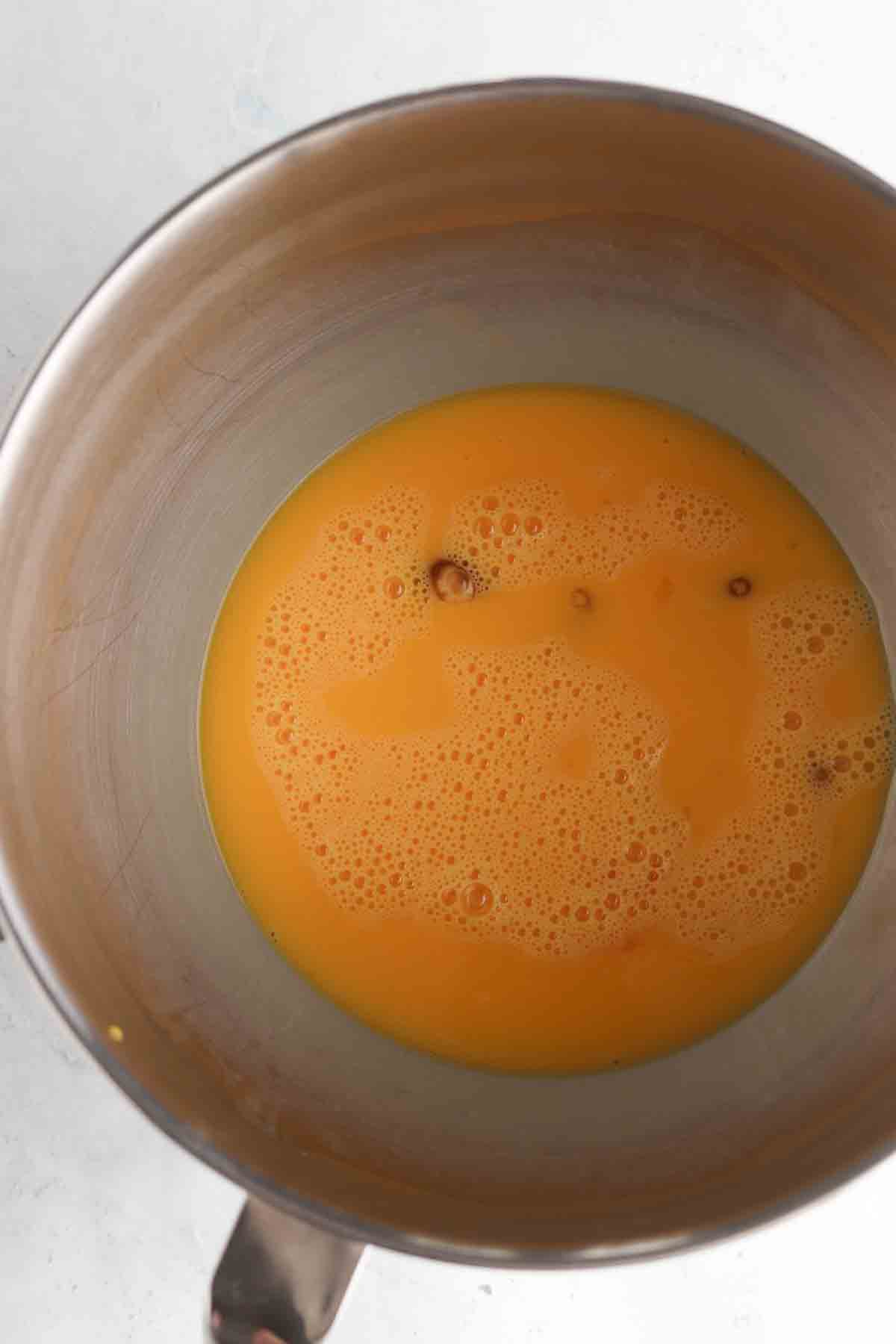 Whisked eggs in a large bowl.