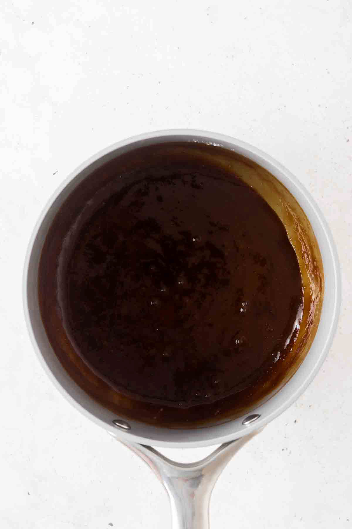 Dairy free caramel sauce in a saucepan.
