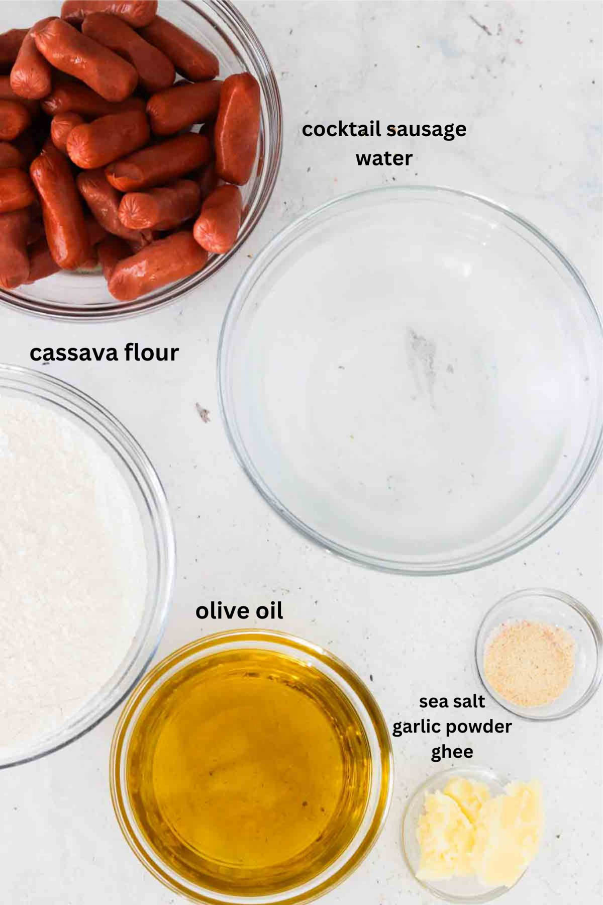Mini sausages, cassava flour, water, oil, garlic and salt in small bowls.