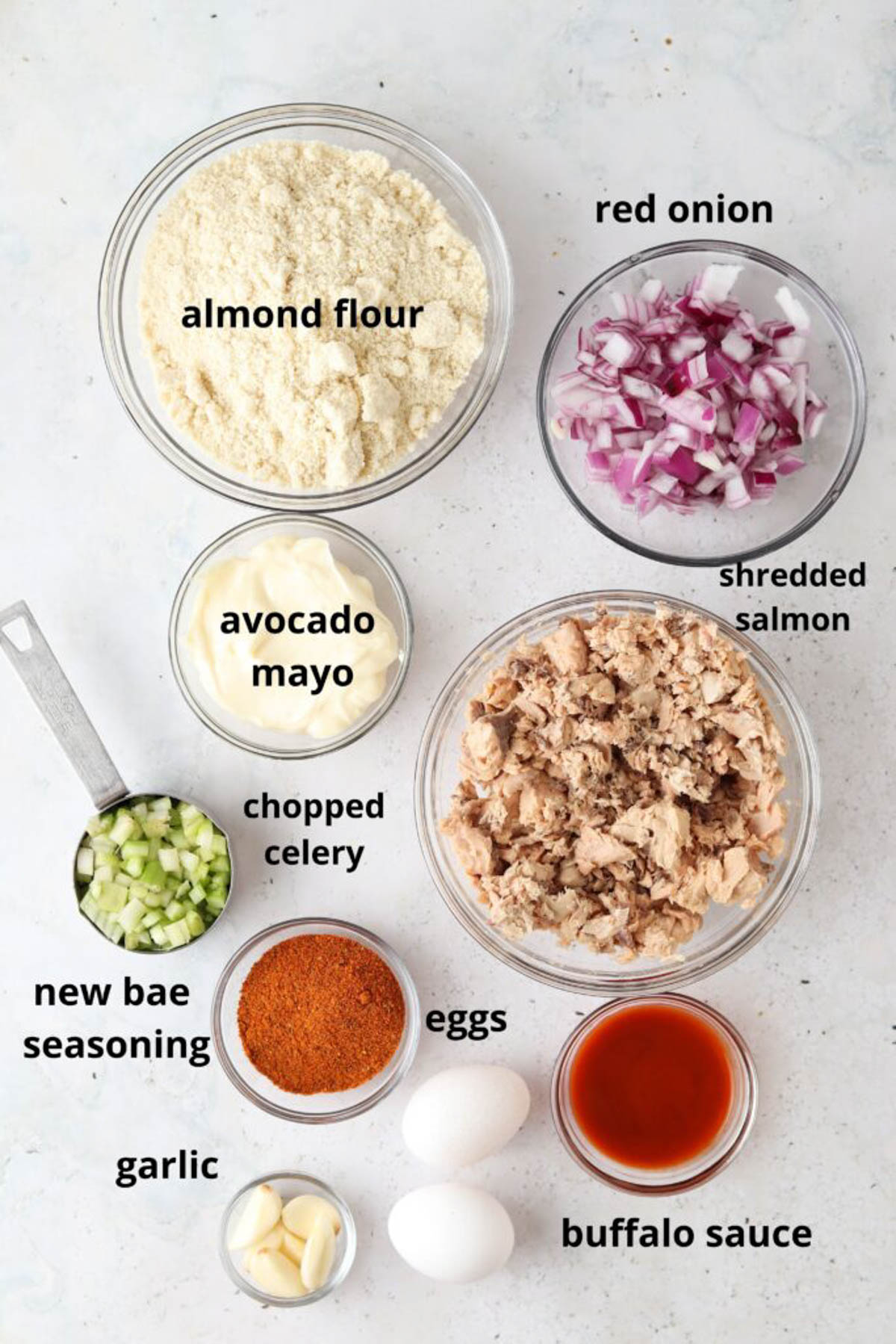 Gluten free salmon cake ingredients in small glass bowls. 