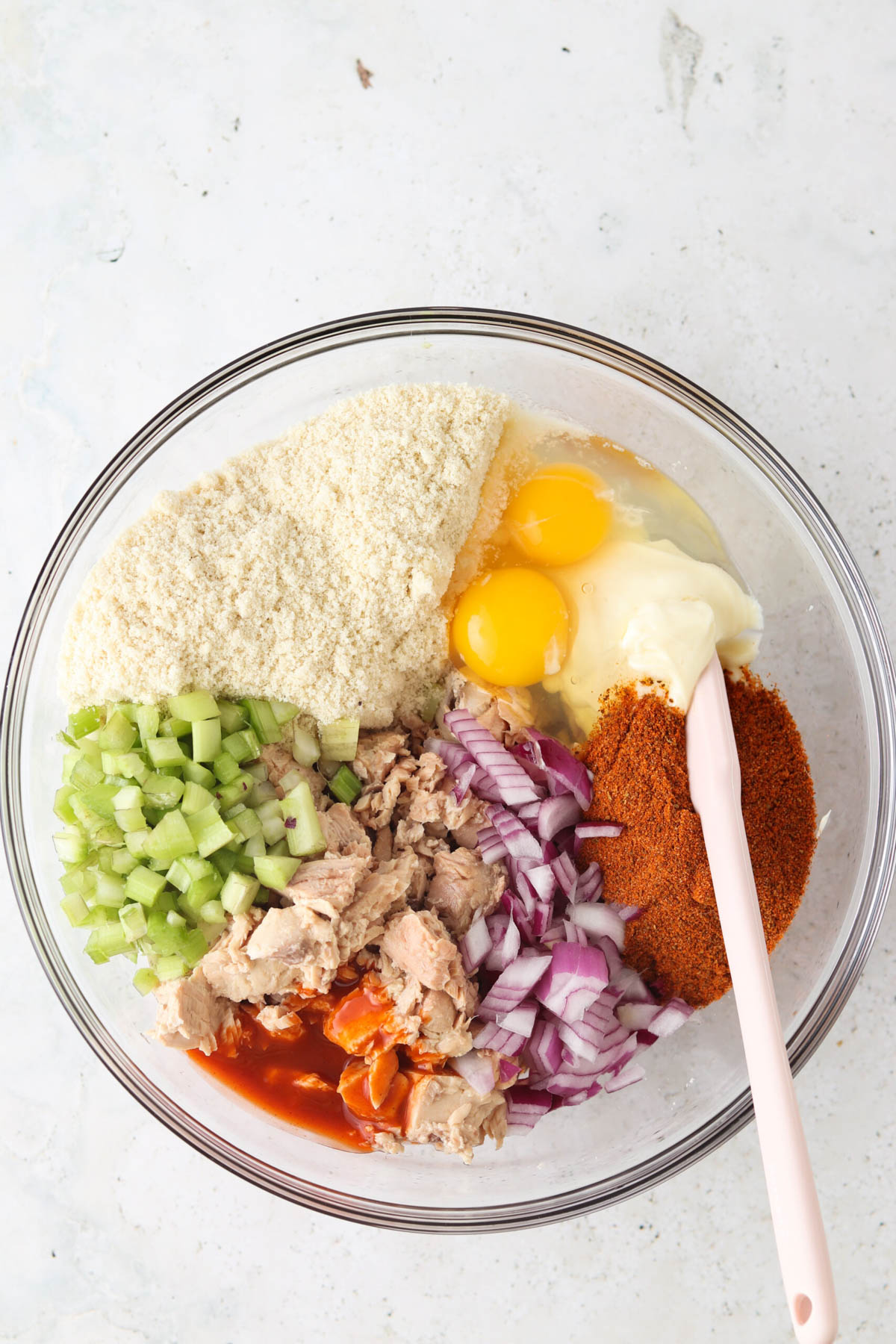 Salmon cake ingredients all in a large glass bowl. 