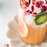 Grapefruit mocktail in a glass with jalapeño slice and grapefruit slice.