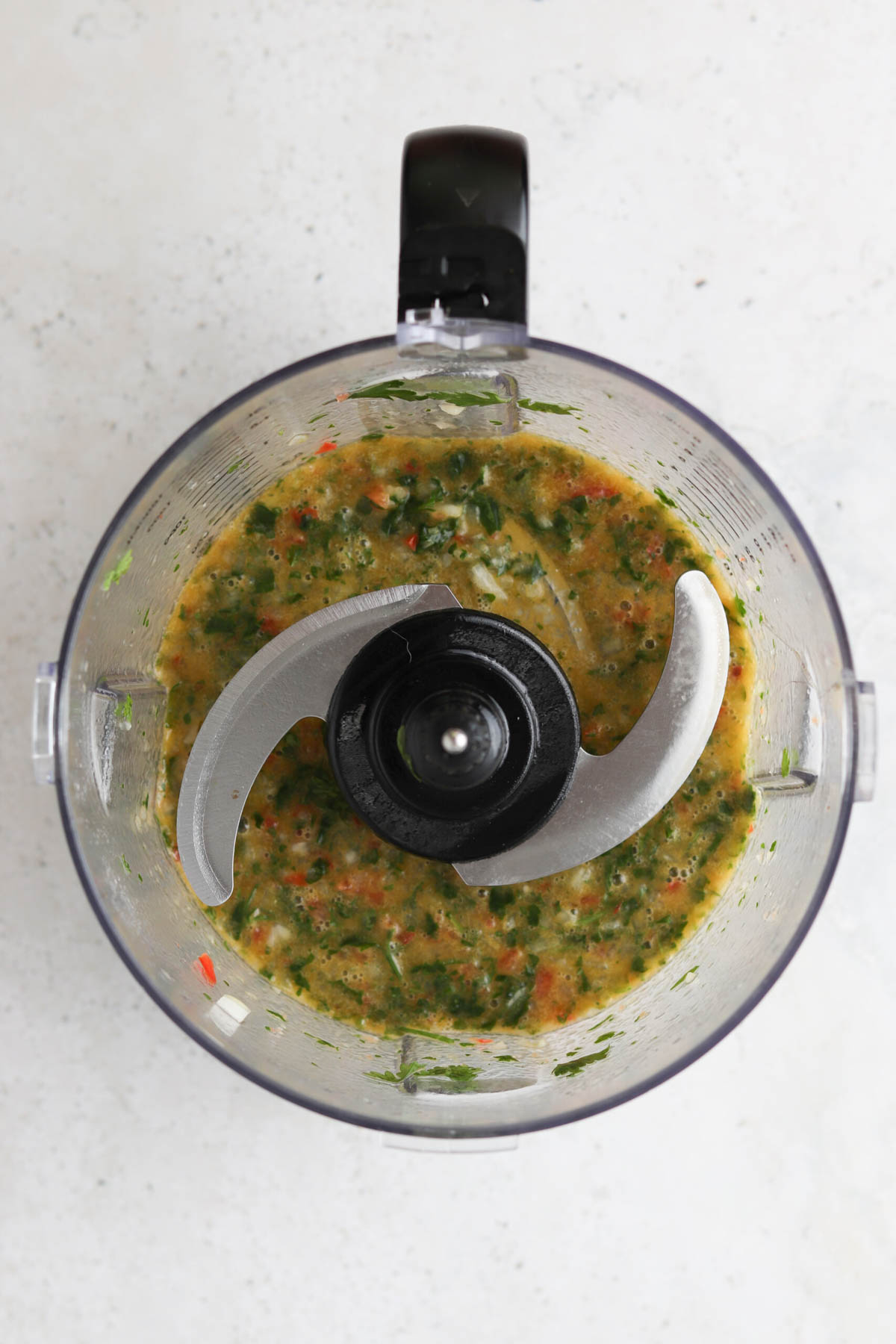 Blended chimichurri sauce ingredients. 