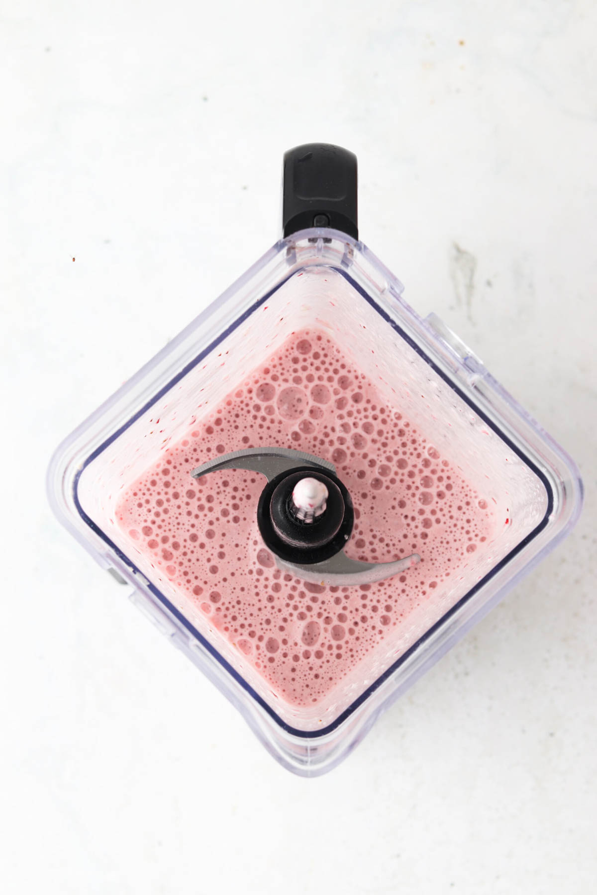 Blended up strawberry smoothie in a food processor. 