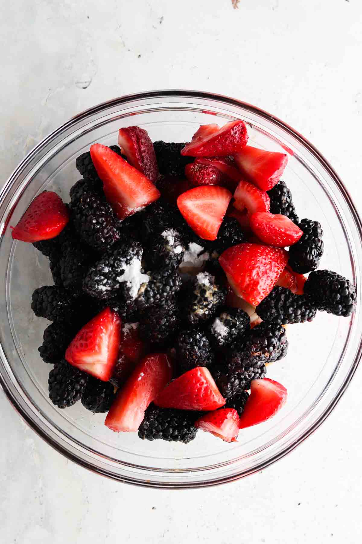 Berry mixture in a glass bowl.