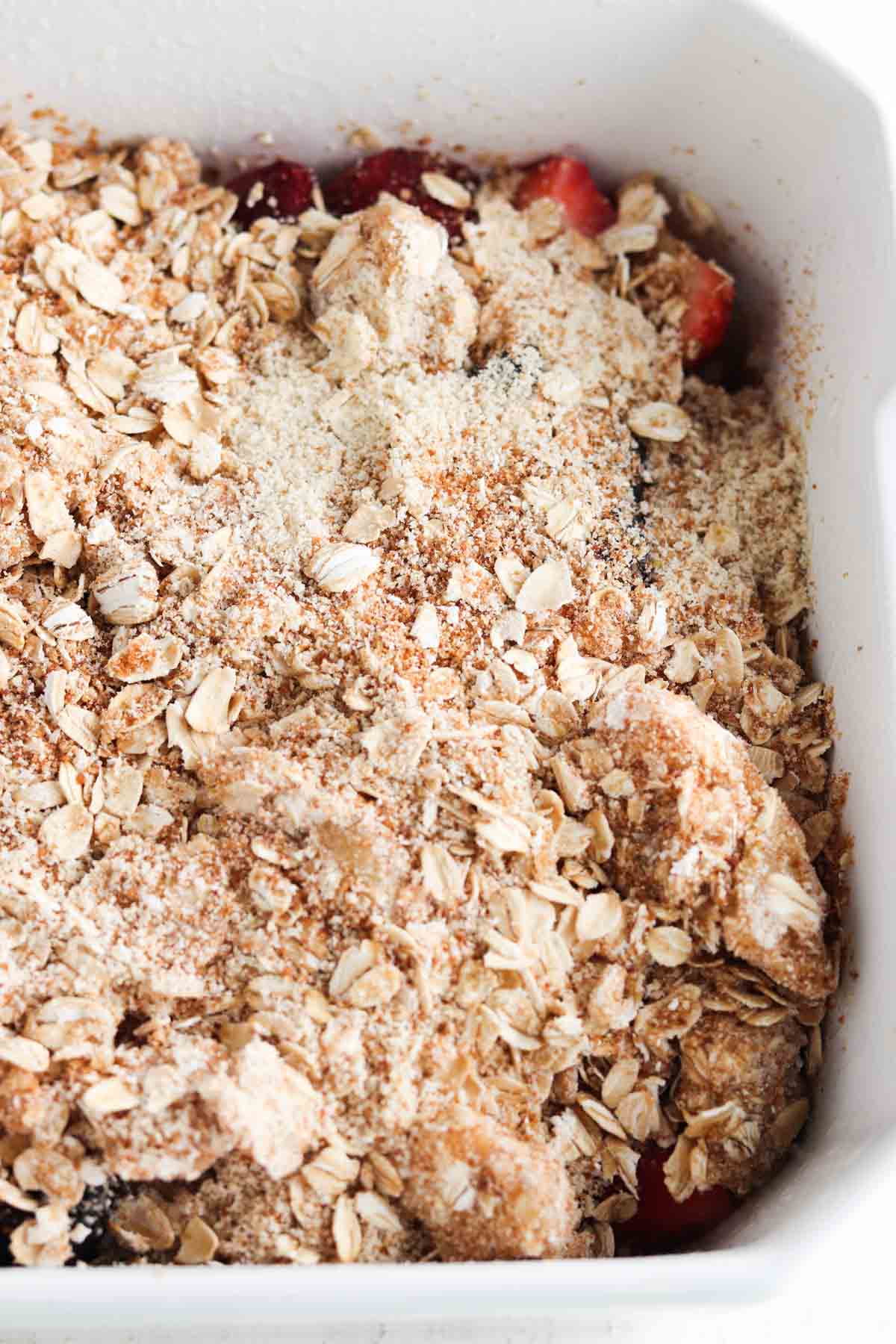 Uncooked berry crisp in a casserole dish.