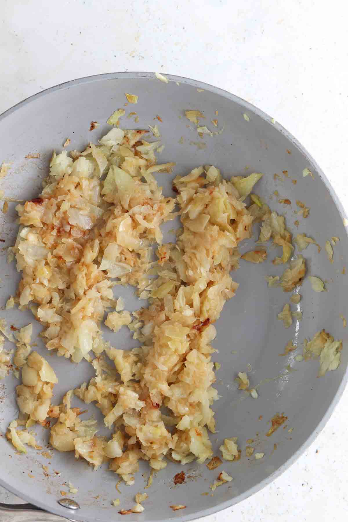 Onions sautéed in a frying pan.  