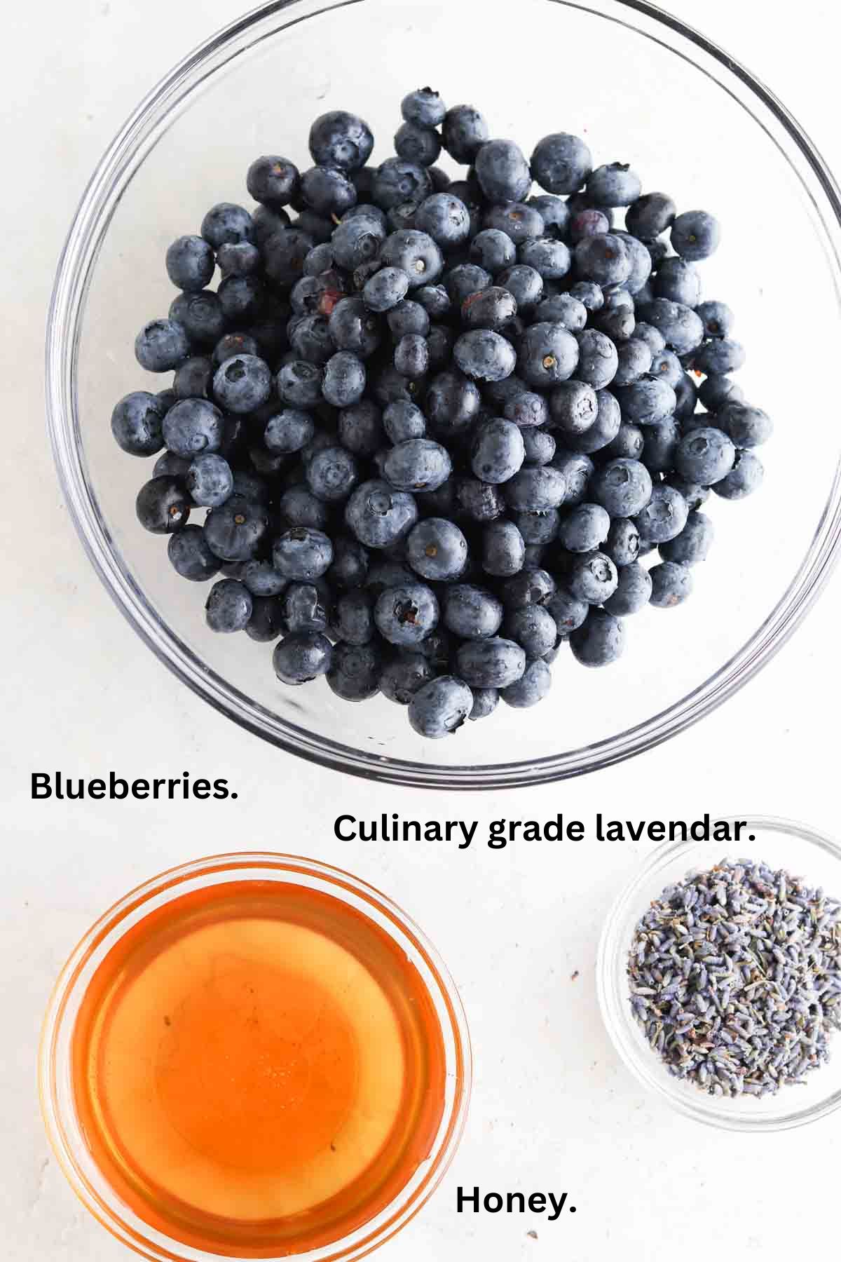 Blueberries, honey, and culinary grade lavender in small bowls. 