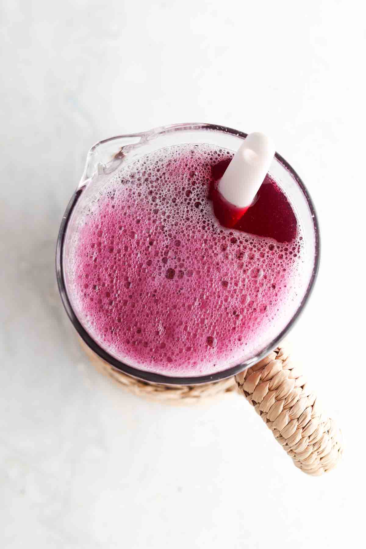 Blueberry simple syrup, lemon juice and water in a large bowl mixed together. 