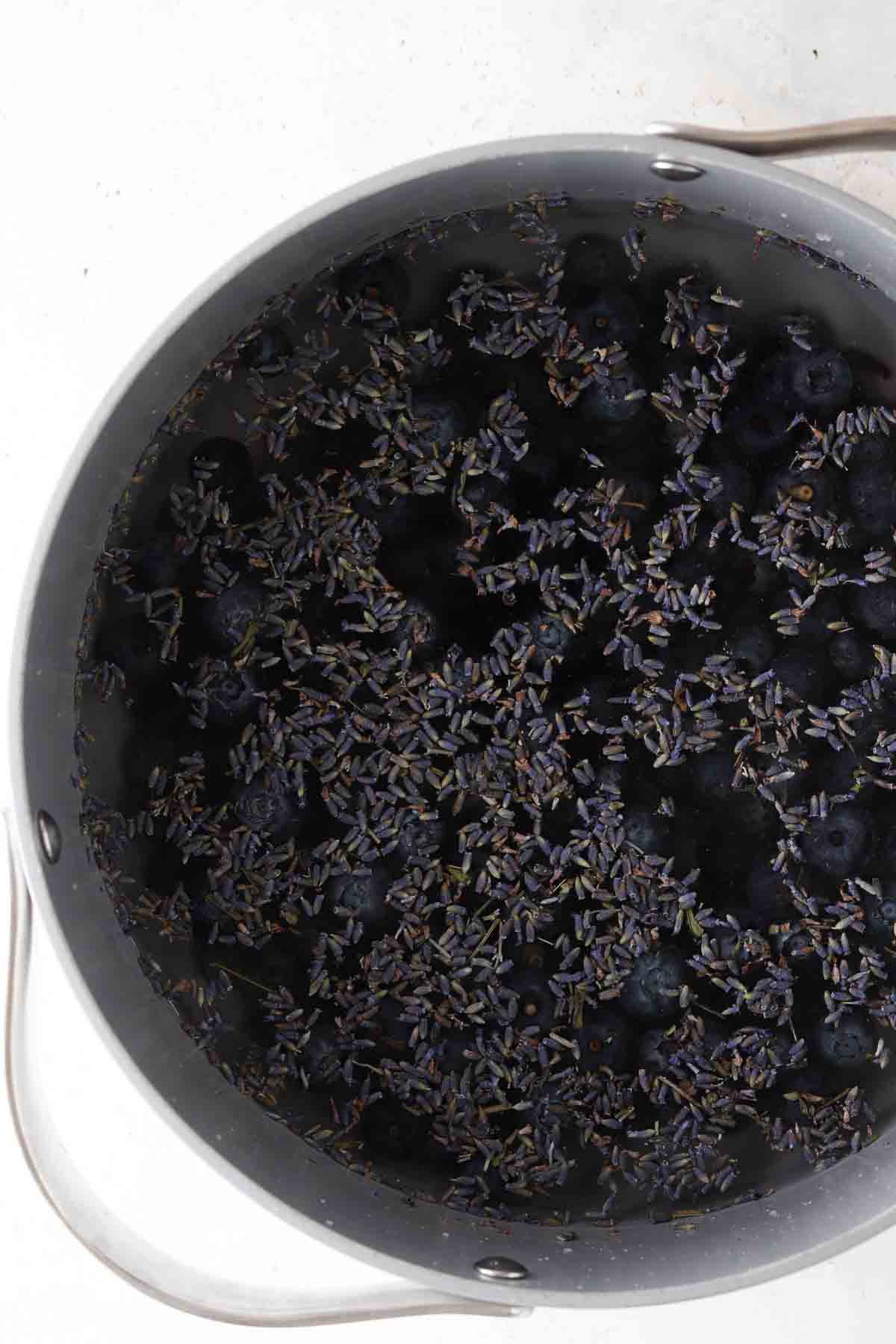 Blueberries, water, honey, and culinary grade lavender in a large pot.
