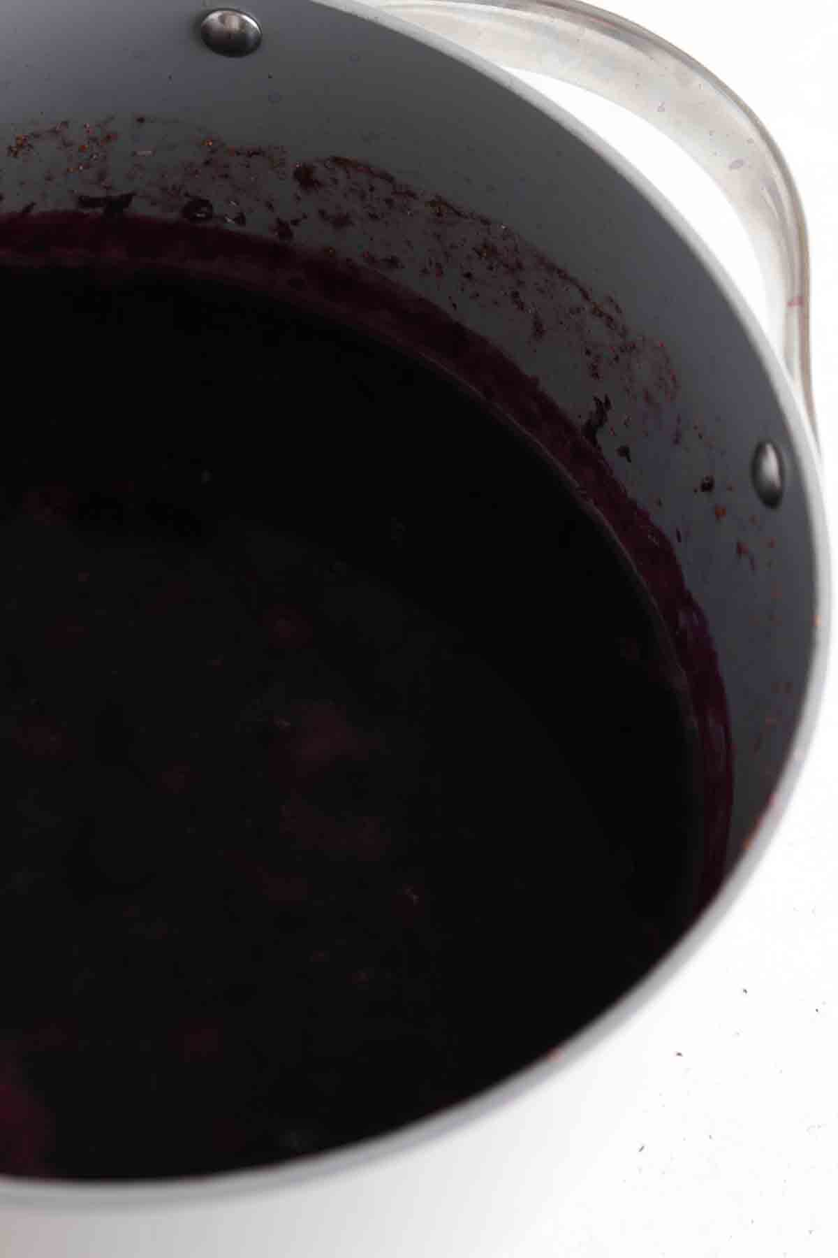 Boiled blueberries, water, honey and lavender in a large pot. 