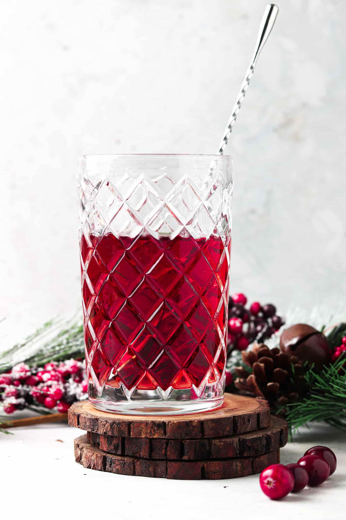 Cranberry juice and lime juice mixed together in a glass jar.