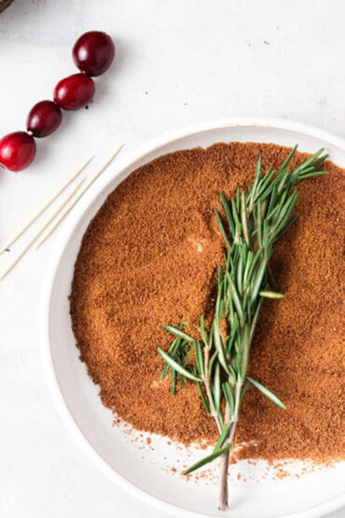 Rosemary laying in coconut sugar. 