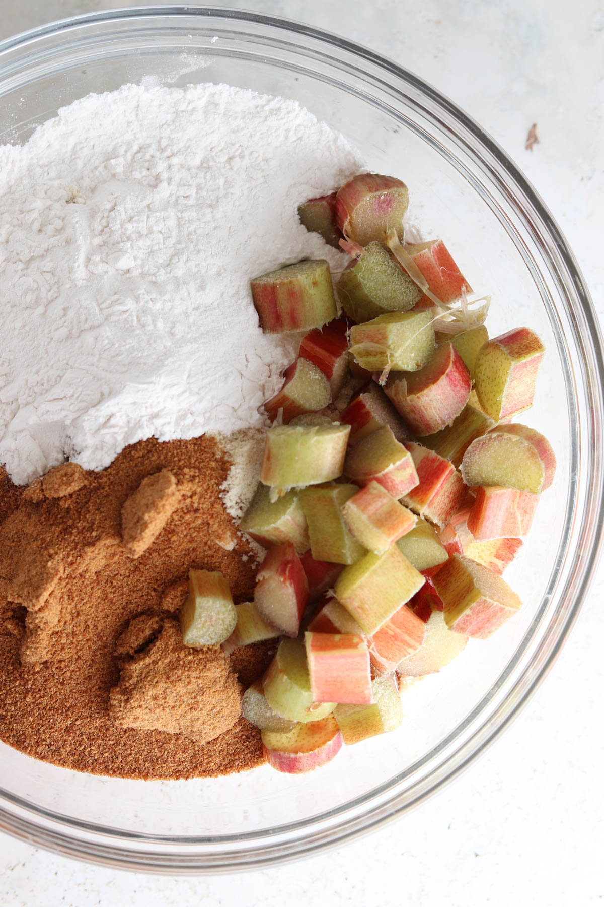 Rhubarb cake wet ingredients in a large glass bowl.