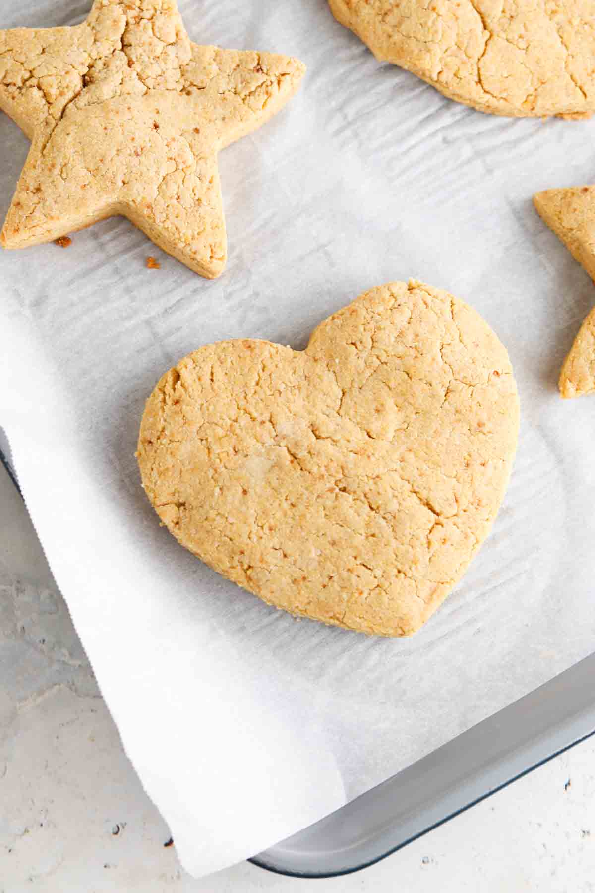 Heart and star sugar cookies on a baking sheet.